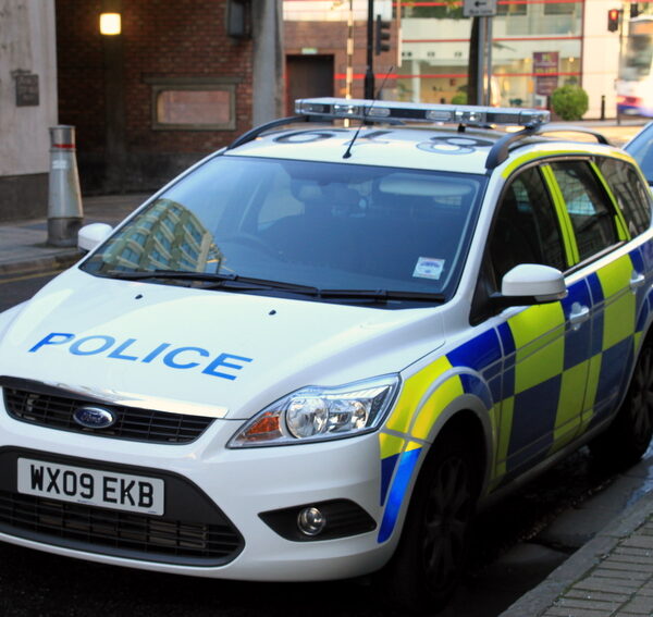A car parked on a street saying "police" on it.