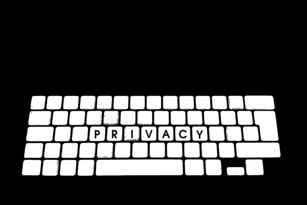A white keyboard spelling out the word "privacy" against a black backdrop.