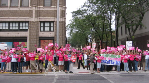 Women dressed in pink rally for reproductive rights.