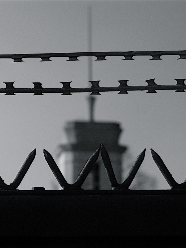 A black and white image of a prison fence.