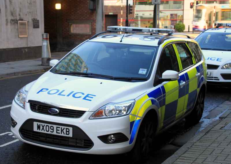 A car parked on a street saying &quot;police&quot; on it.